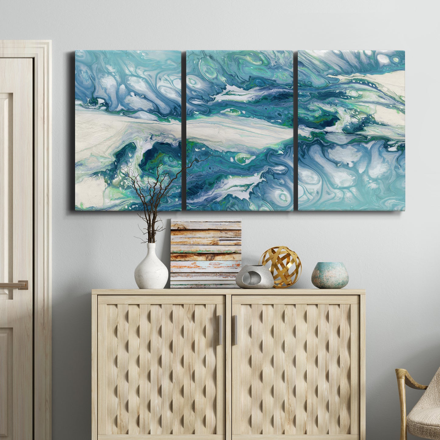 Three-panel canvas wall art featuring layered abstract marble textures, displayed above a cabinet in an entryway.
