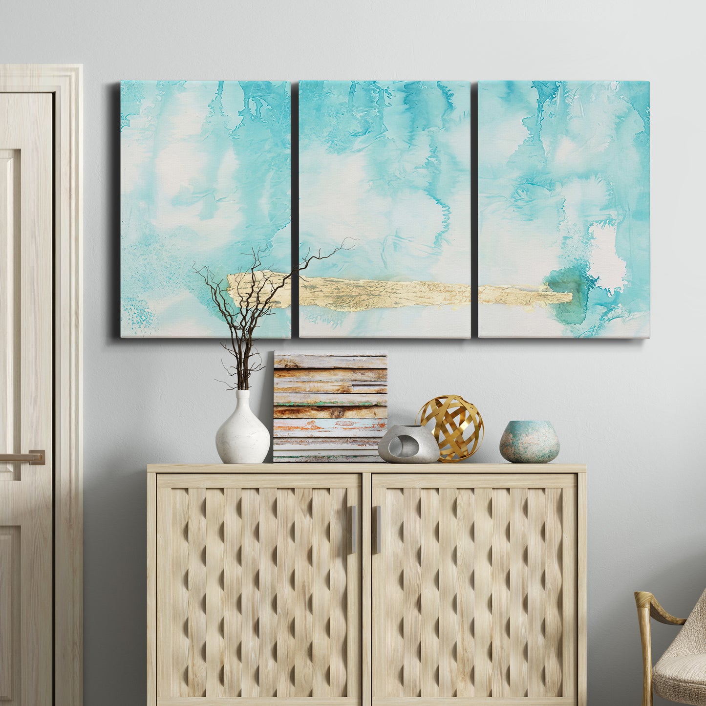 Three-panel canvas wall art featuring saturated abstract color fields, displayed above a cabinet in an entryway.