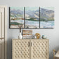 Three-panel canvas wall art featuring pastel mountain landscape view, displayed above a cabinet in an entryway.
