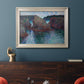 Impressionist rocky seascape by Claude Monet in an ornate champagne frame displayed in a dark-toned interior setting.