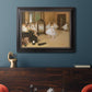 Impressionist dance class interior scene by Edgar Degas in an ornate black frame with gilded inner detail displayed in a dark-toned interior setting.