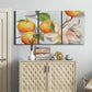 Three-panel canvas wall art featuring bright tangerine still life blossoms, displayed above a cabinet in an entryway.