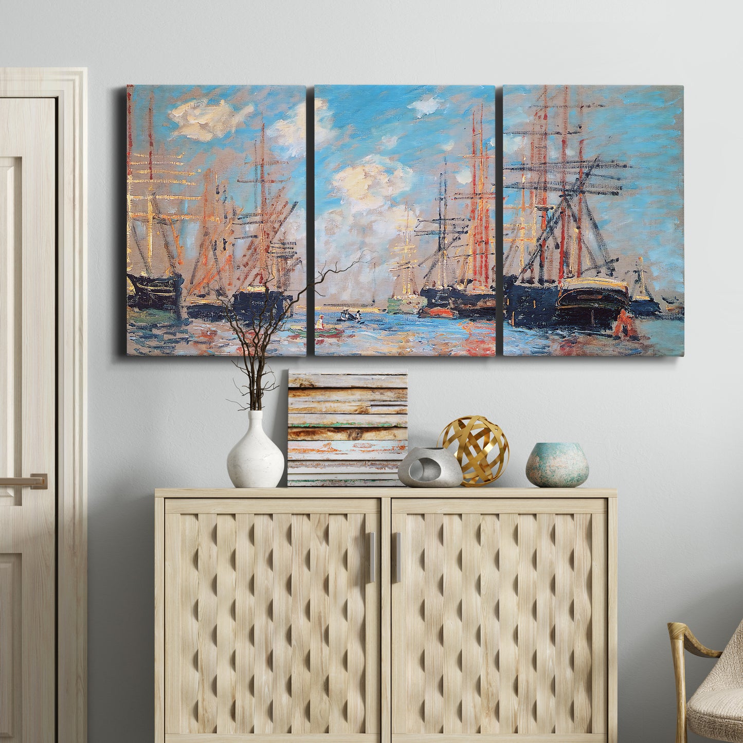 Three-panel canvas wall art featuring harbor with boats and water, displayed above a cabinet in an entryway.