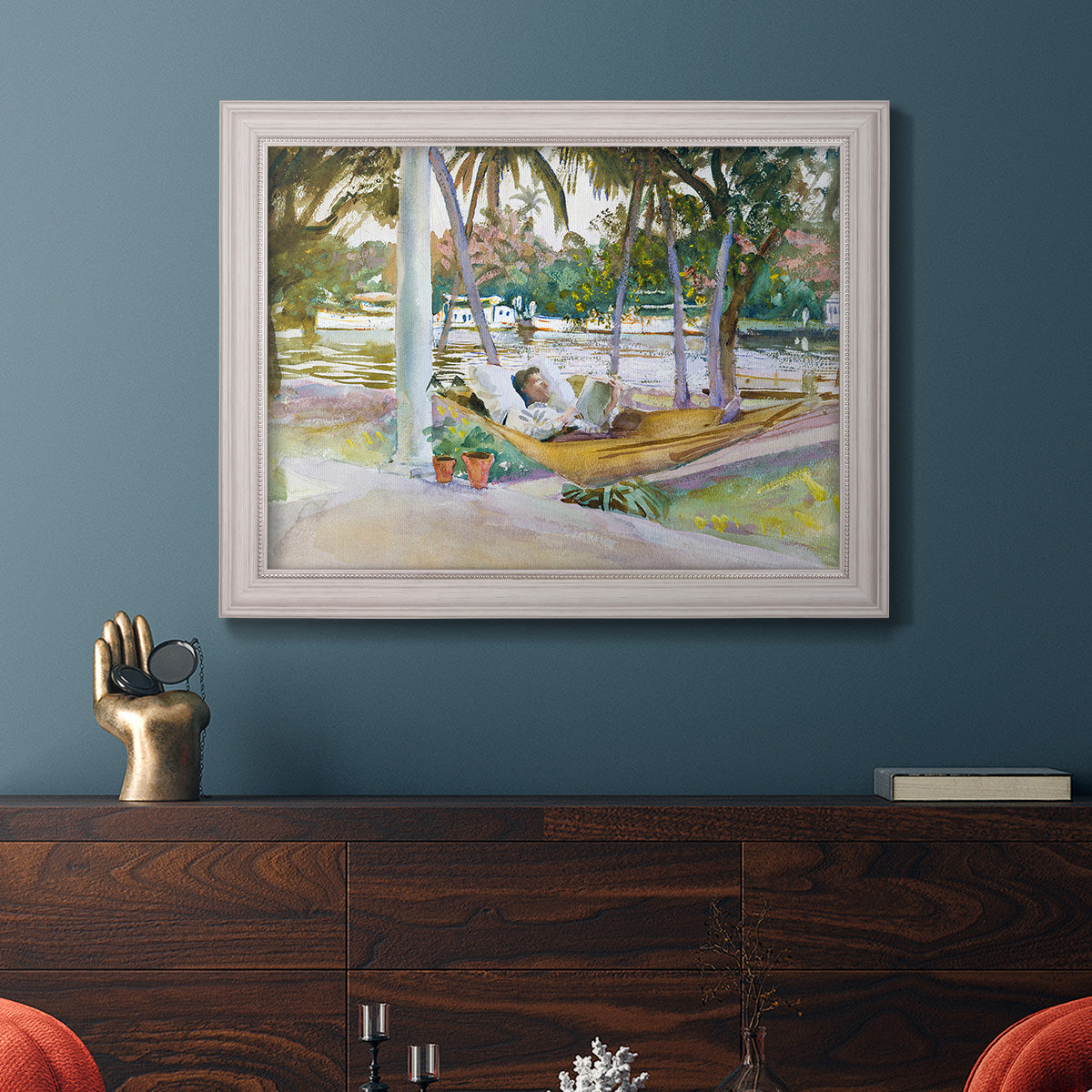 Impressionist leisure portrait scene by John Singer Sargent in an ornate weathered white frame displayed in a dark-toned interior setting.