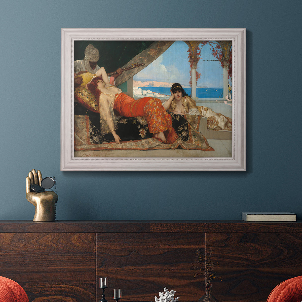 Orientalist portrait scene by Jean-Joseph Benjamin-Constant in an ornate weathered white frame displayed in a dark-toned interior setting.