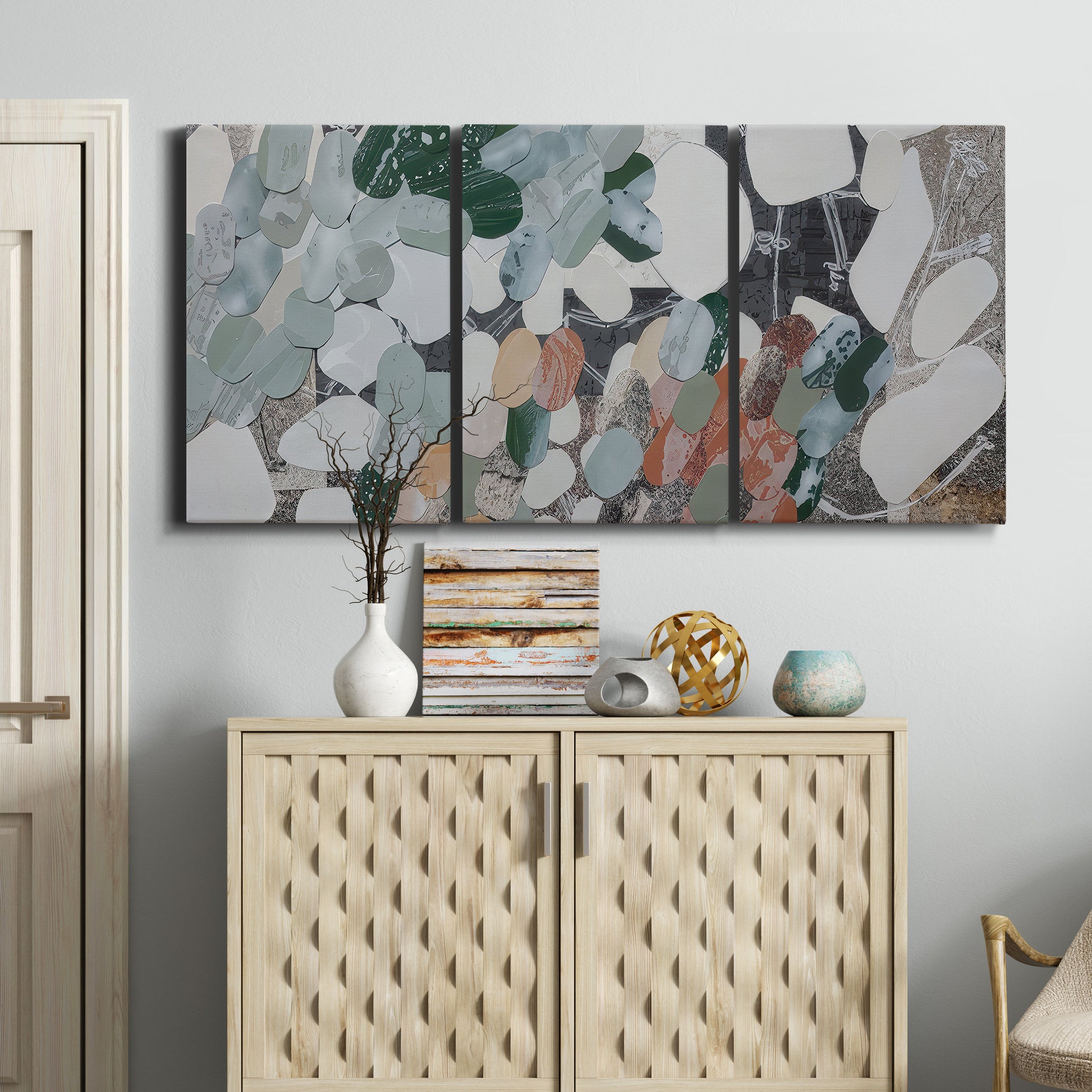 Three-panel canvas wall art featuring layered canyon inspired abstract forms, displayed above a cabinet in an entryway.