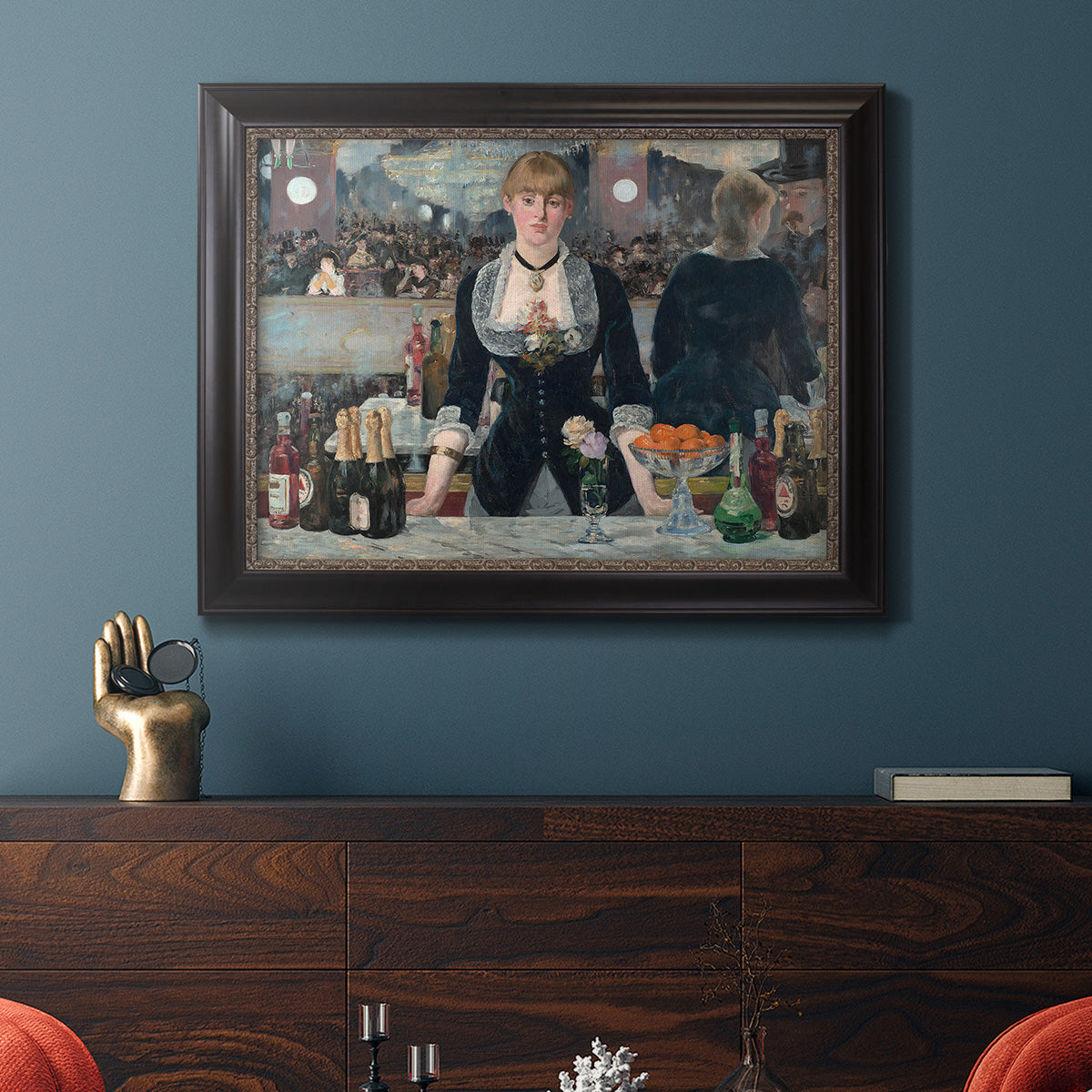 Iconic impressionist café bar scene by Édouard Manet in an ornate black frame with gilded inner detail displayed in a dark-toned interior setting.