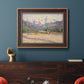 Impressionist valley landscape in southern France by Claude Monet in an ornate bronzed mahogany wood frame displayed in a dark-toned interior setting.