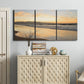 Three-panel canvas wall art featuring quiet tropical shoreline at low tide, displayed above a cabinet in an entryway.