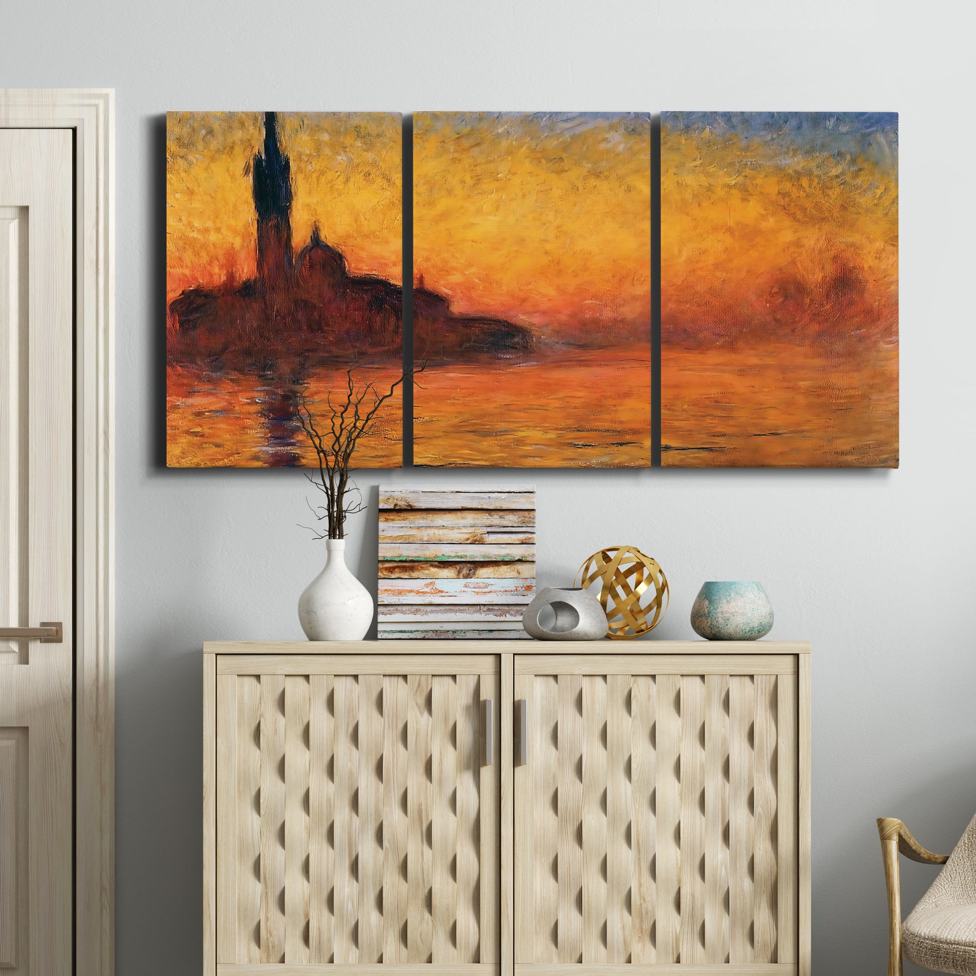 Three-panel canvas wall art featuring Venetian church at sunset, displayed above a cabinet in an entryway.