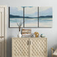 Three-panel canvas wall art featuring soft coastal shoreline landscape, displayed above a cabinet in an entryway.