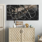 Three-panel canvas wall art featuring dark swirling abstract motion, displayed above a cabinet in an entryway.