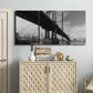 Three-panel canvas wall art featuring manhattan bridge industrial cityscape, displayed above a cabinet in an entryway.