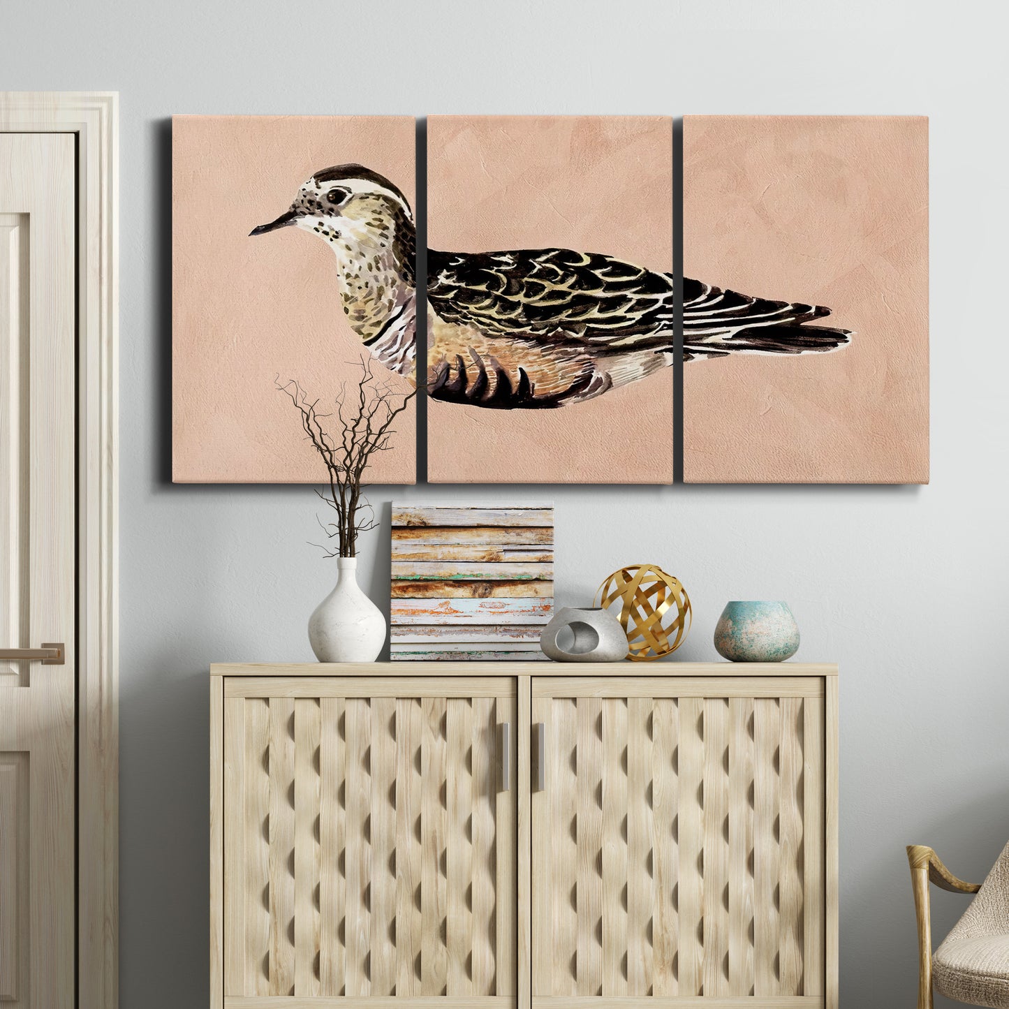 Three-panel canvas wall art featuring coastal bird illustration, displayed above a cabinet in an entryway.