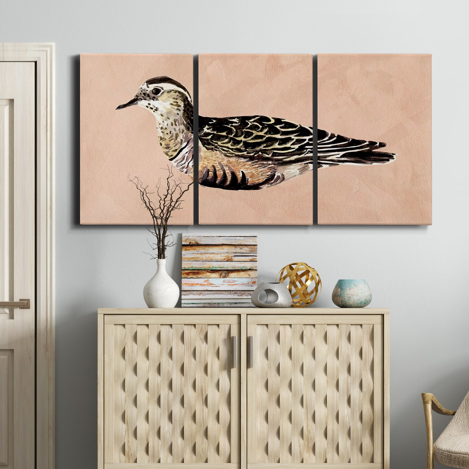 Three-panel canvas wall art featuring coastal bird illustration, displayed above a cabinet in an entryway.