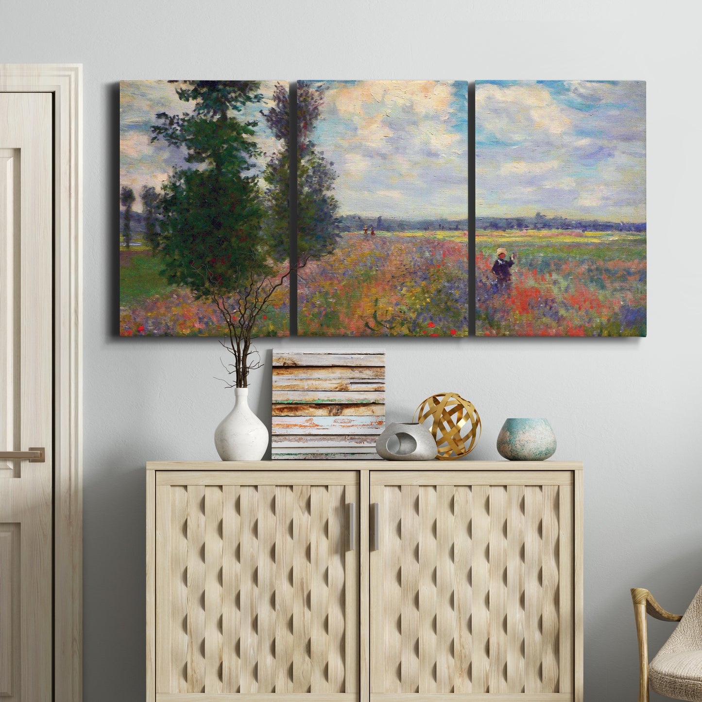 Three-panel canvas wall art featuring poppy field in open countryside, displayed above a cabinet in an entryway.