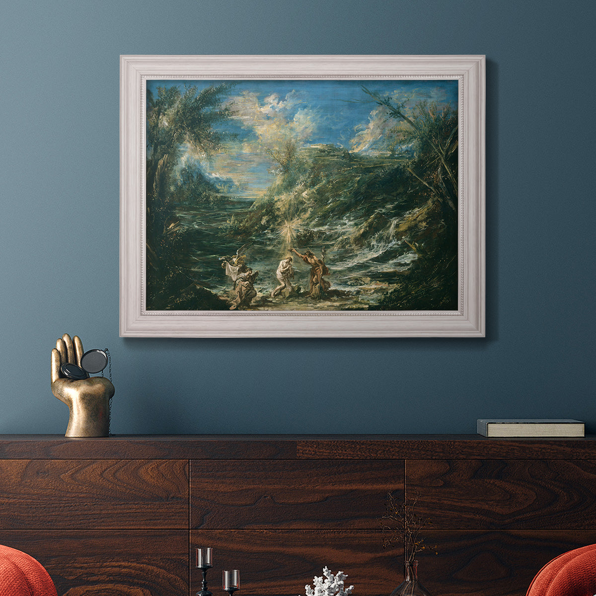 Religious landscape depicting the baptism of Christ by Alessandro Magnasco in an ornate weathered white frame displayed in a dark-toned interior setting.