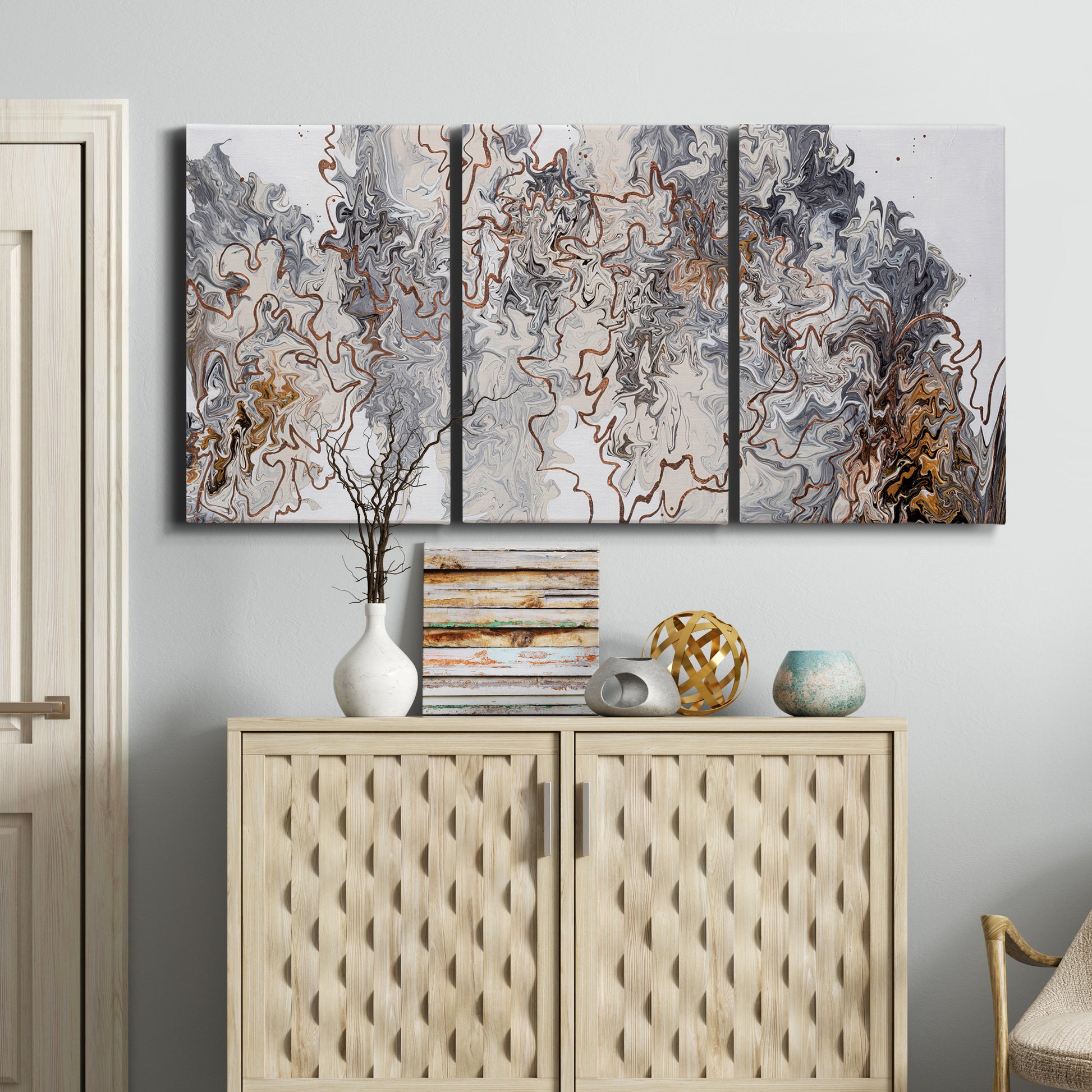 Three-panel canvas wall art featuring wooded trail through forest, displayed above a cabinet in an entryway.