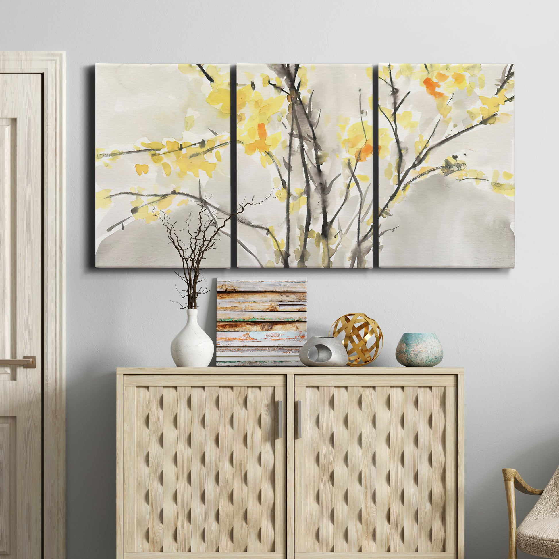 Three-panel canvas wall art featuring soft floral abstract harmony, displayed above a cabinet in an entryway.