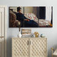Three-panel canvas wall art featuring woman resting on sofa indoors, displayed above a cabinet in an entryway.