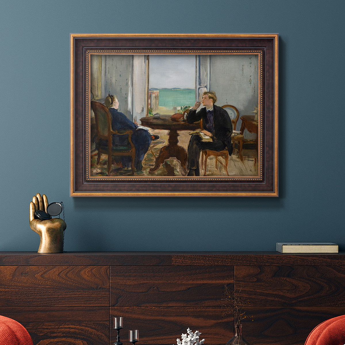 Impressionist interior scene by Édouard Manet in an ornate bronzed mahogany wood frame displayed in a dark-toned interior setting.