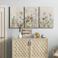 Three-panel canvas wall art featuring loose farmhouse style floral painting, displayed above a cabinet in an entryway.