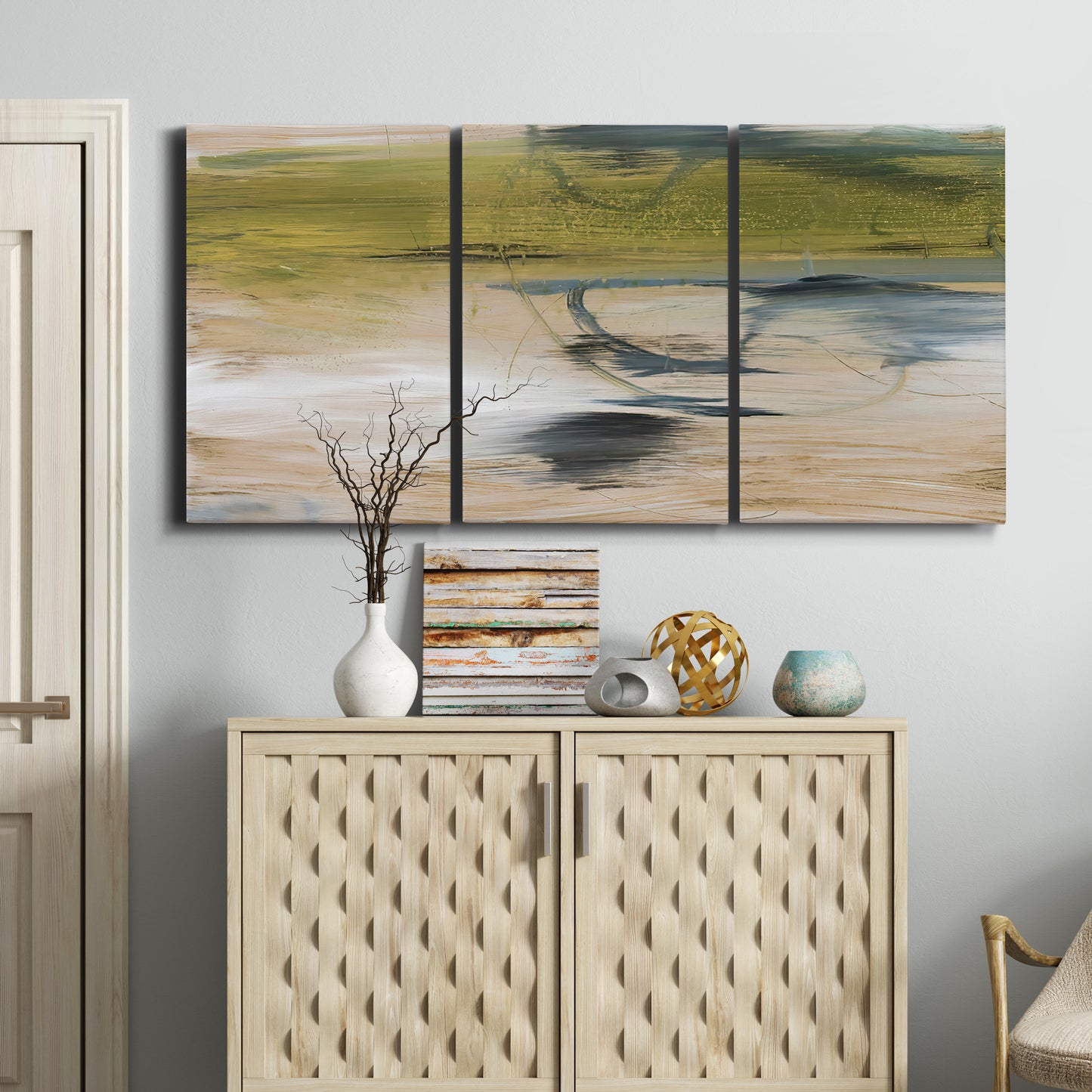 Three-panel canvas wall art featuring minimal abstract water reflections, displayed above a cabinet in an entryway.