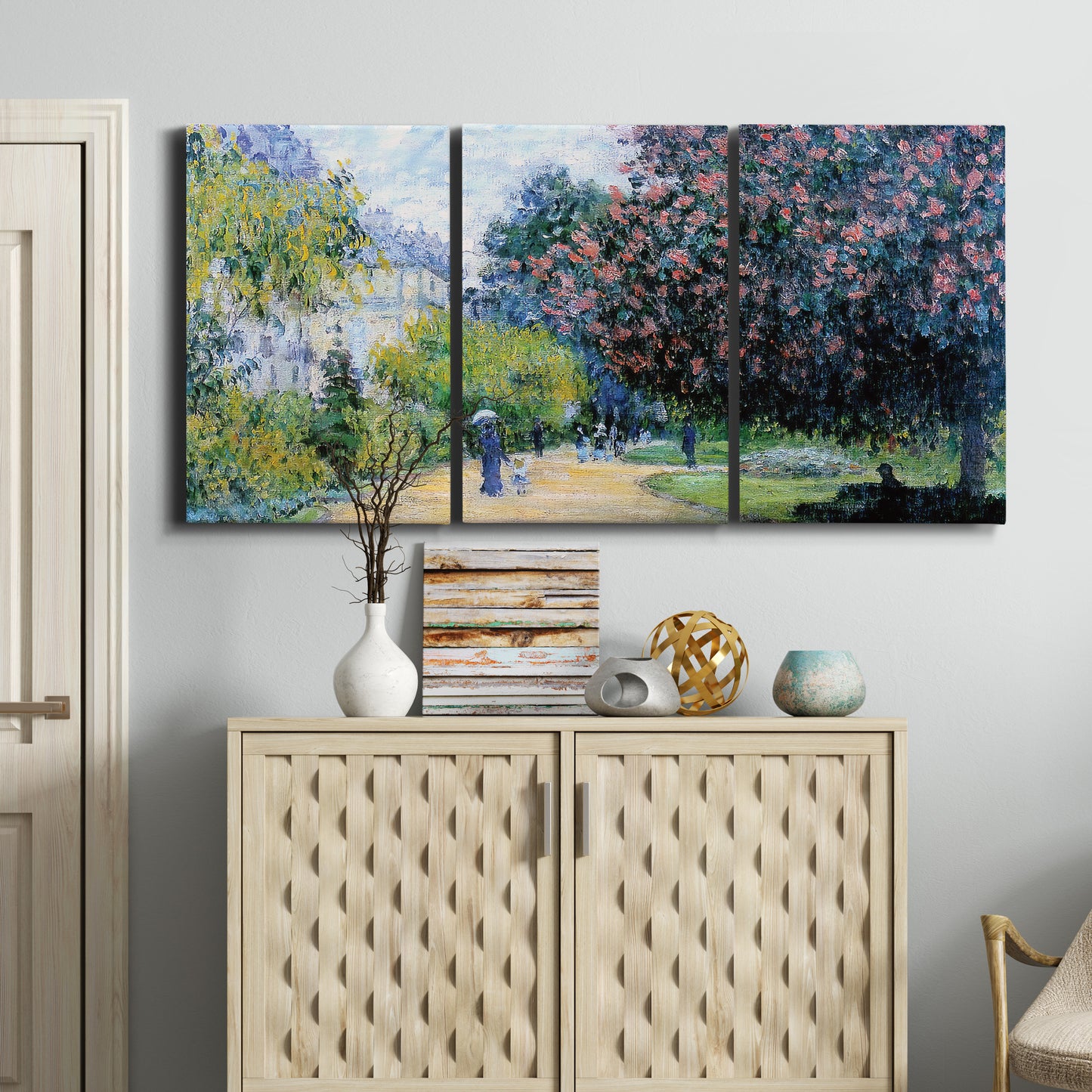 Three-panel canvas wall art featuring formal city park with trees, displayed above a cabinet in an entryway.
