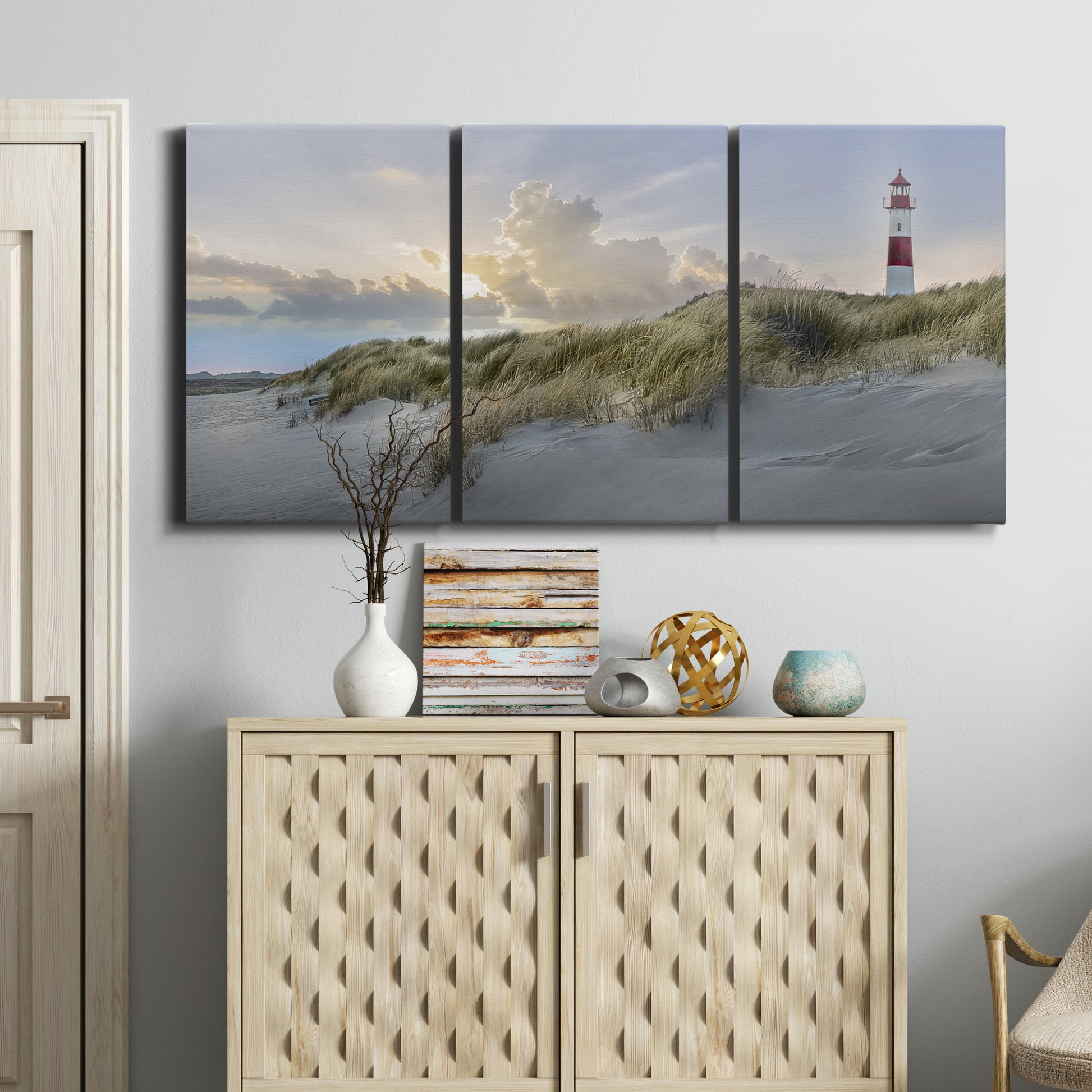 Three-panel canvas wall art featuring guardian boat along shoreline, displayed above a cabinet in an entryway.
