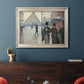 Impressionist urban street scene in the rain by Gustave Caillebotte in an ornate champagne frame displayed in a dark-toned interior setting.