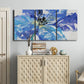 Three-panel canvas wall art featuring blue floral botanical close up, displayed above a cabinet in an entryway.