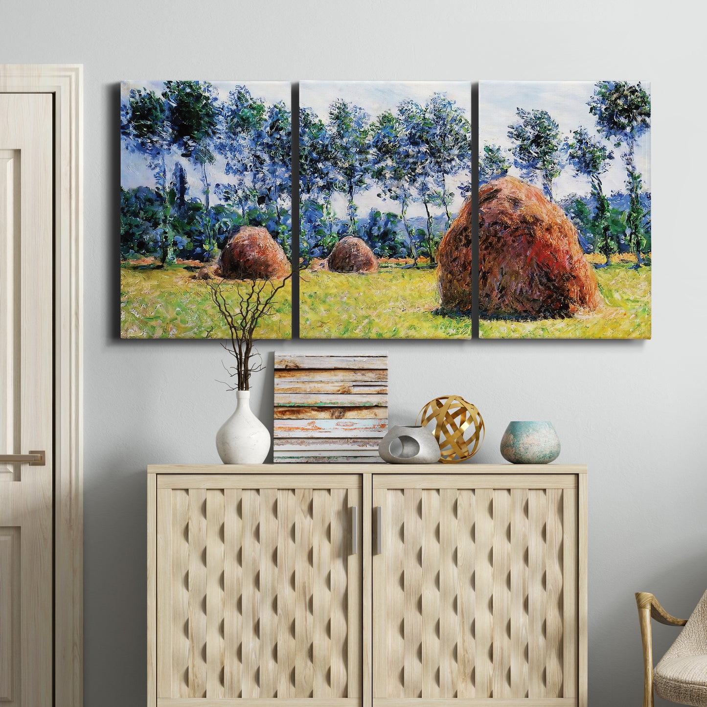 Three-panel canvas wall art featuring harvested grainstacks in field, displayed above a cabinet in an entryway.