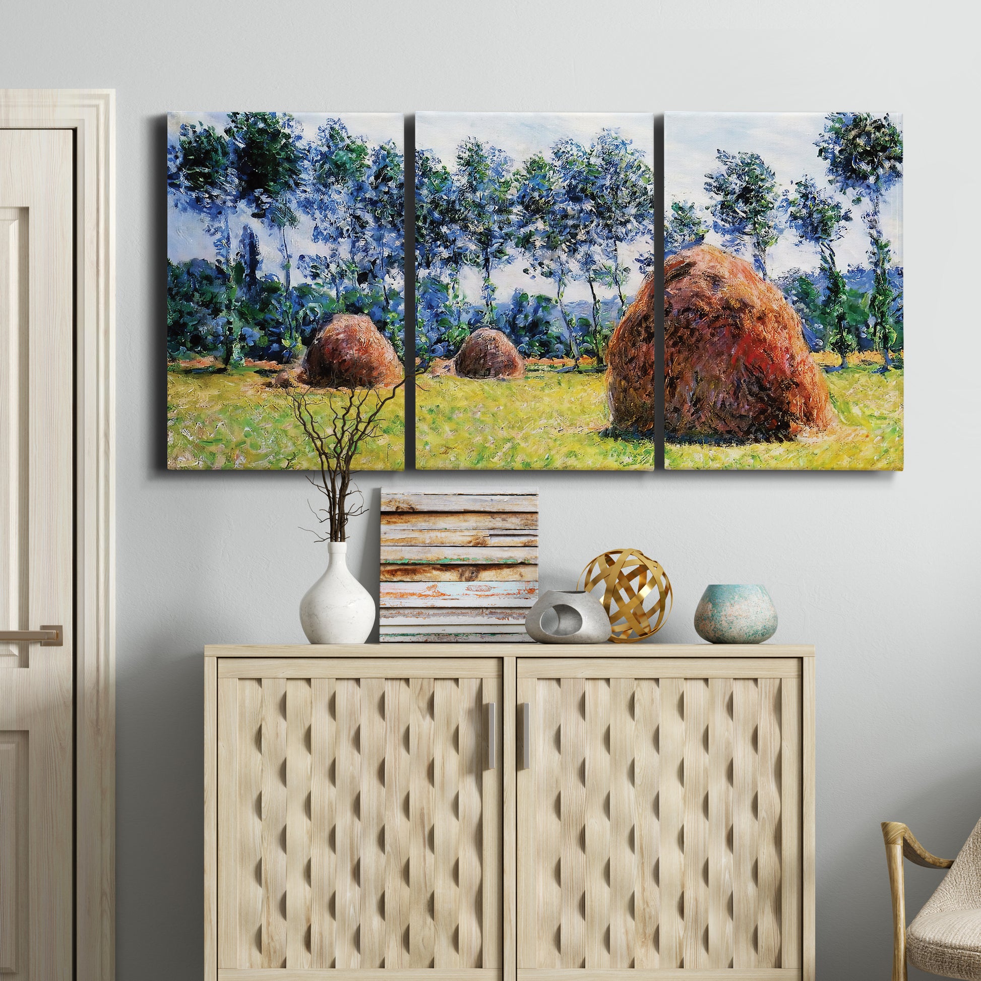 Three-panel canvas wall art featuring harvested grainstacks in field, displayed above a cabinet in an entryway.