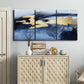 Three-panel canvas wall art featuring coastal shoreline with warm light, displayed above a cabinet in an entryway.
