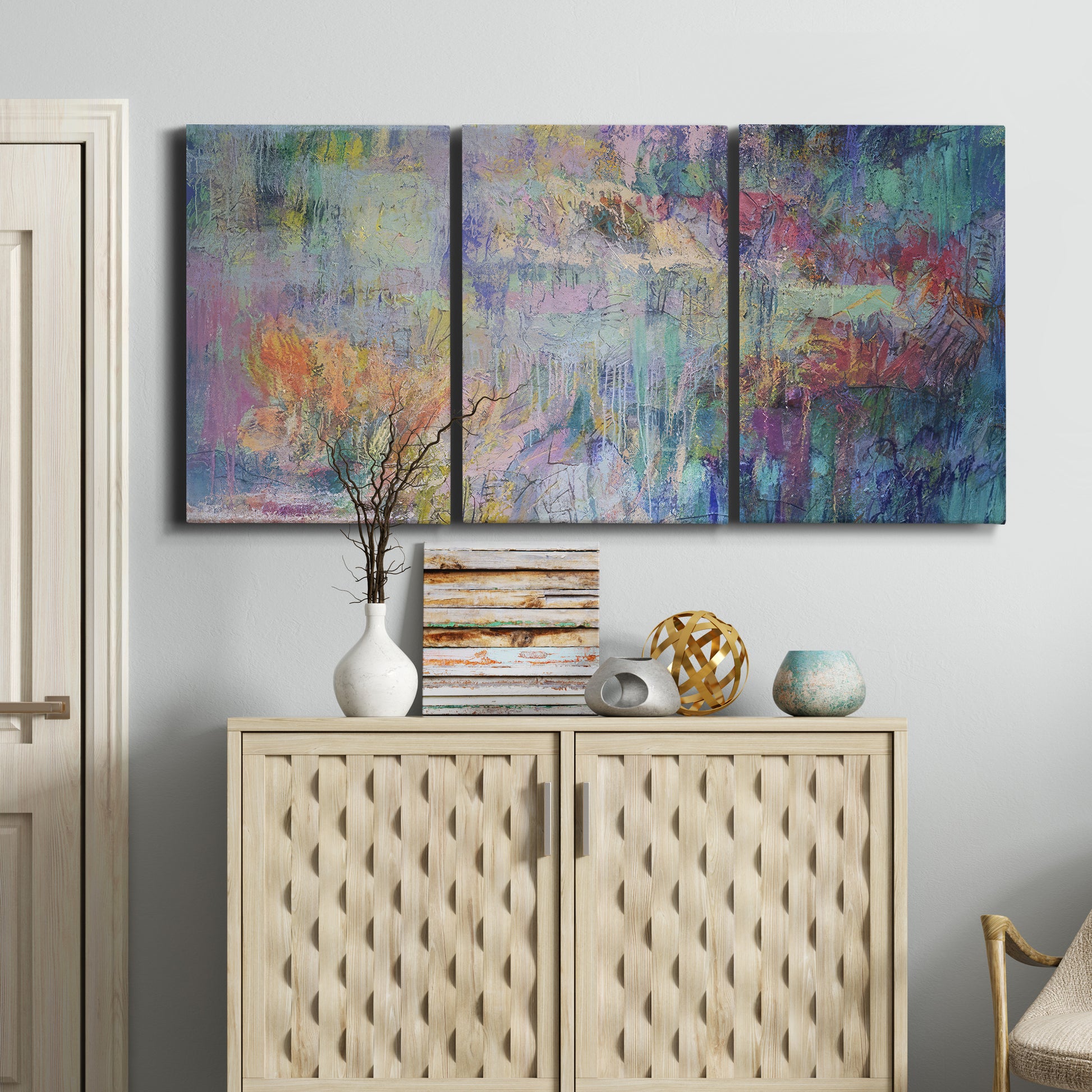 Three-panel canvas wall art featuring abstract evening landscape with depth, displayed above a cabinet in an entryway.