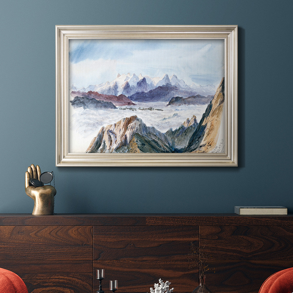 Impressionist alpine mountain landscape by John Singer Sargent in an ornate champagne frame displayed in a dark-toned interior setting.