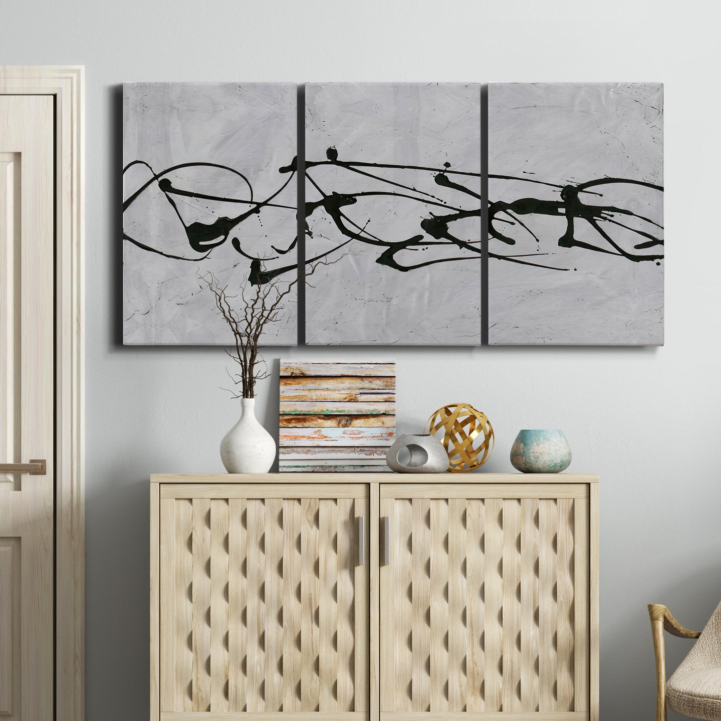 Three-panel canvas wall art featuring minimal abstract frequency lines, displayed above a cabinet in an entryway.