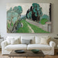 Canvas art print detailing a bright natural view with cypress and olive trees, centered above a sofa as a large focal wall piece