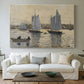 Canvas art print detailing a coastal view featuring two schooners under clear sky, centered above a sofa as a large focal wall piece