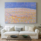 Canvas art print detailing a simplified landscape using texture and color variation, centered above a sofa as a large focal wall piece