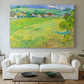 Canvas art print detailing a stylized rural composition with fields and sky, centered above a sofa as a large focal wall piece