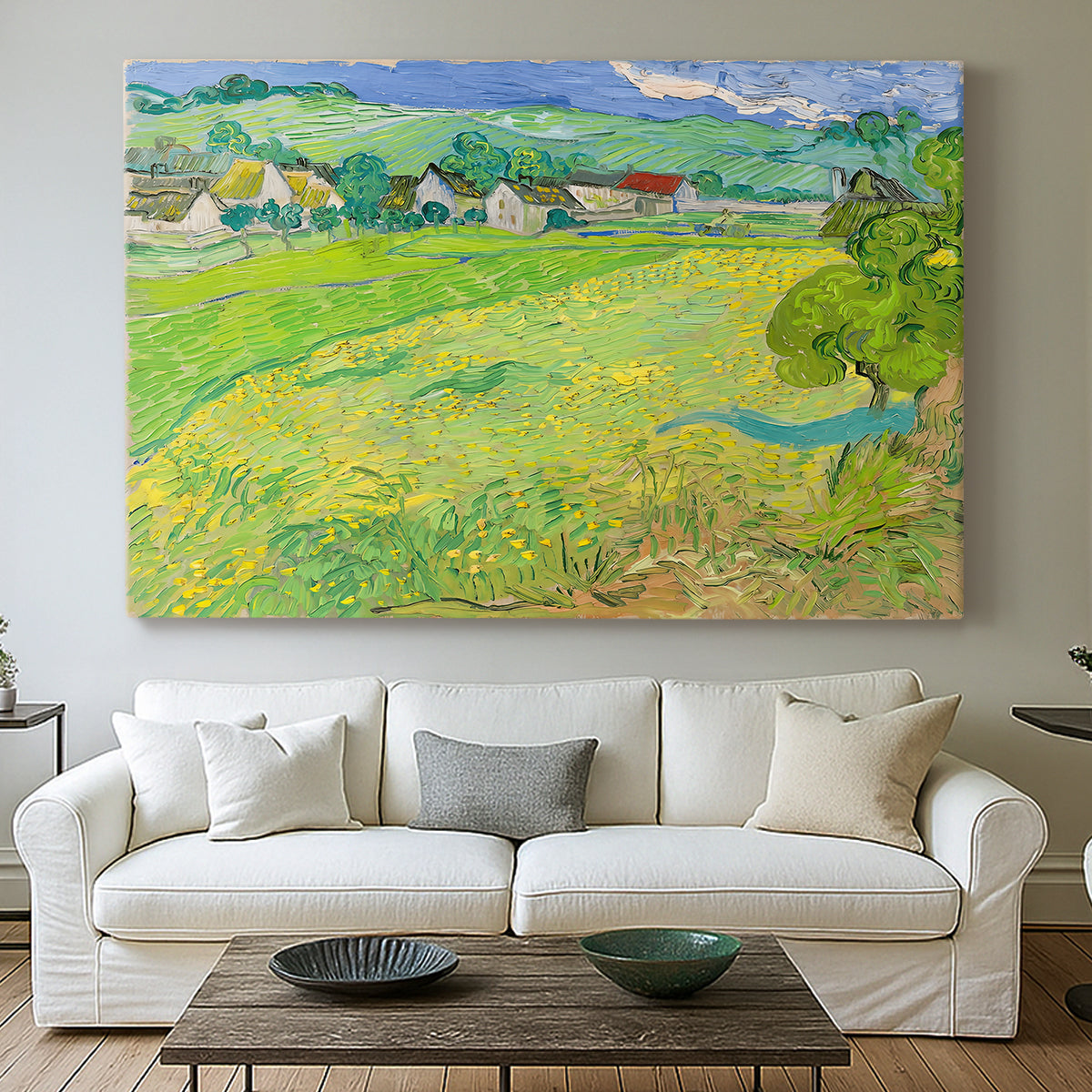 Canvas art print detailing a stylized rural composition with fields and sky, centered above a sofa as a large focal wall piece