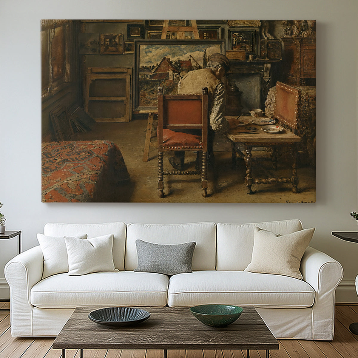 Canvas art print detailing a quiet workspace with figure engaged in artistic task, centered above a sofa as a large focal wall piece
