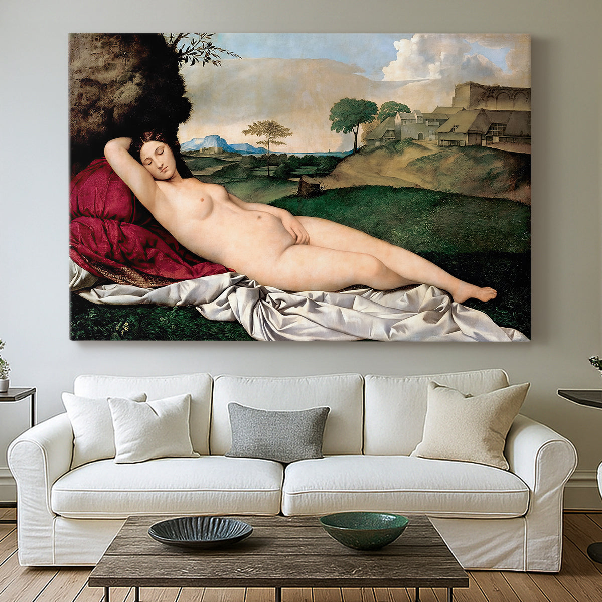Canvas art print detailing a classical reclining nude surrounded by gentle landscape, centered above a sofa as a large focal wall piece
