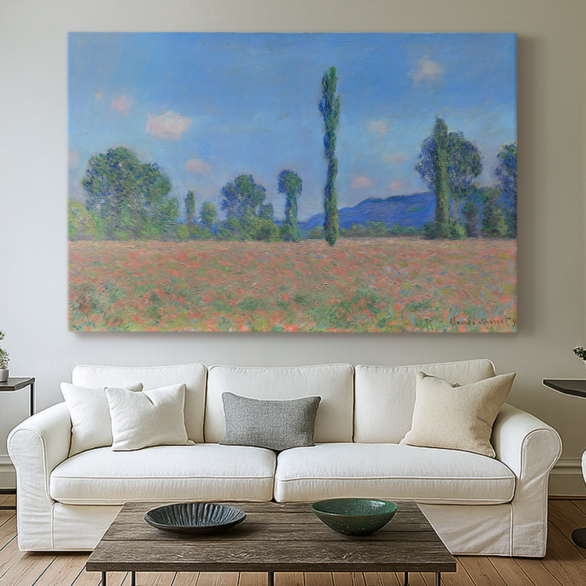 Canvas art print detailing a rural field filled with red blossoms beneath open sky, centered above a sofa as a large focal wall piece