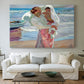 Canvas art print detailing an impressionist beach scene with soft movement and light, centered above a sofa as a large focal wall piece