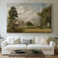 Canvas art print detailing a countryside view with house and vegetation, centered above a sofa as a large focal wall piece