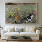 Canvas art print detailing a naturalistic depiction of cat in blooming countryside setting, centered above a sofa as a large focal wall piece