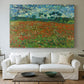 Canvas art print detailing an open field composition with low horizon and vegetation, centered above a sofa as a large focal wall piece