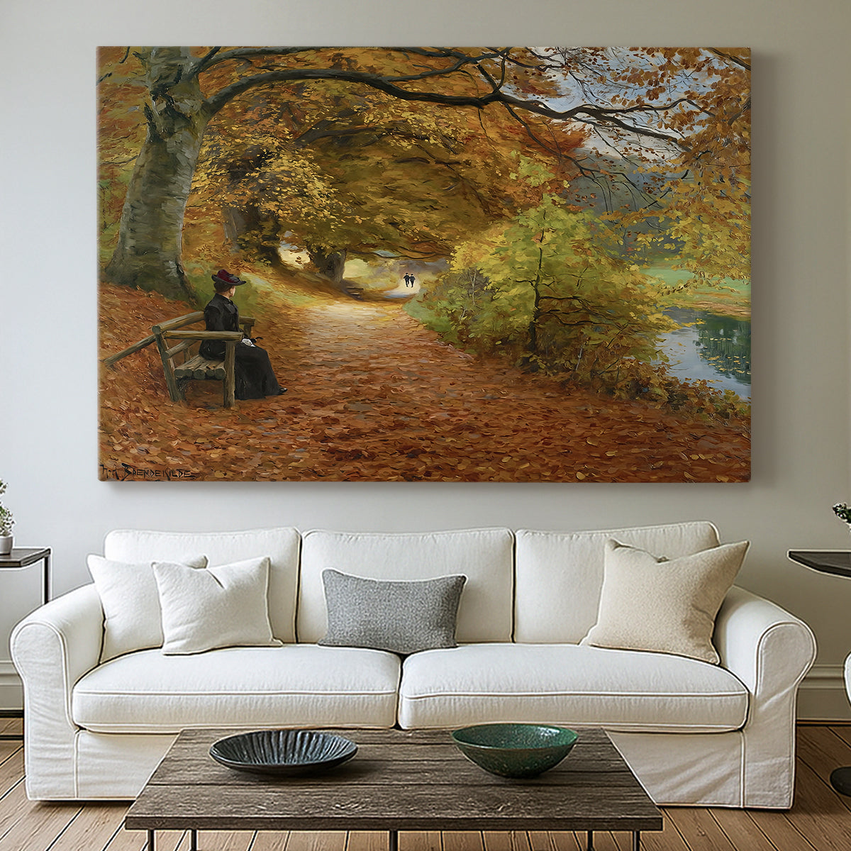 Canvas art print detailing a peaceful autumn setting with figures in wooded environment, centered above a sofa as a large focal wall piece